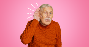 Older man holding hand to ear to hear better